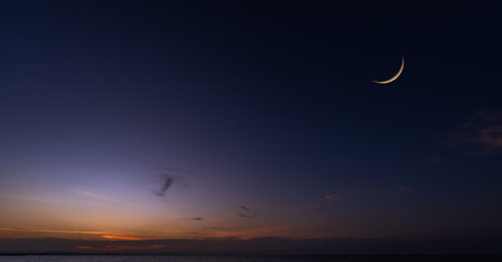 Crescent moon on dusk sky sunset after sun down twilight over sea, Horizon landscape countryside,...
