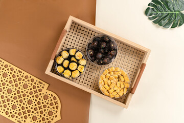 Top view of three jars of Indonesian cookies nastar, kastengel, and chocolate arranged in a woven...