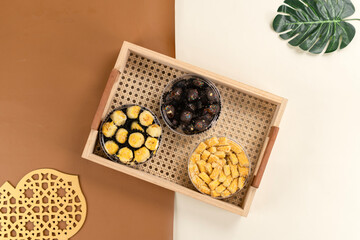 Top view of three jars of Indonesian cookies nastar, kastengel, and chocolate arranged in a woven...