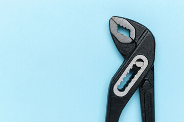 Adjustable Wrench on Light Blue Background: Simple Tools and Mechanics Concept