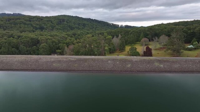 Forested parkland beyond dam wall of Silvan Reservoir