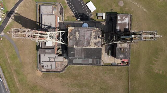 Aerial drone view of coal colliery mine site, industrial revolution legacy infrastructure extracting energy materials from earth Clipstone, Notttingham, England. 