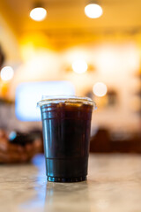Ice americano coffee in a transparent glass at cafe