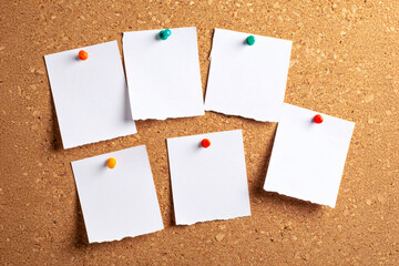 Paper notes sticky in Cork board. note papers on an old wood frame.