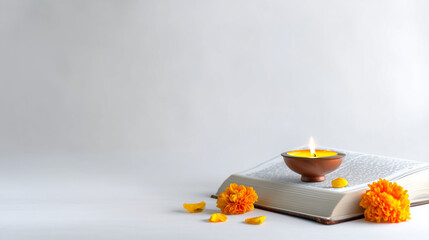 Sacred Gita Jayanti Ritual with Oil Diya on Holy Book and Marigold Flowers for Divine Blessings