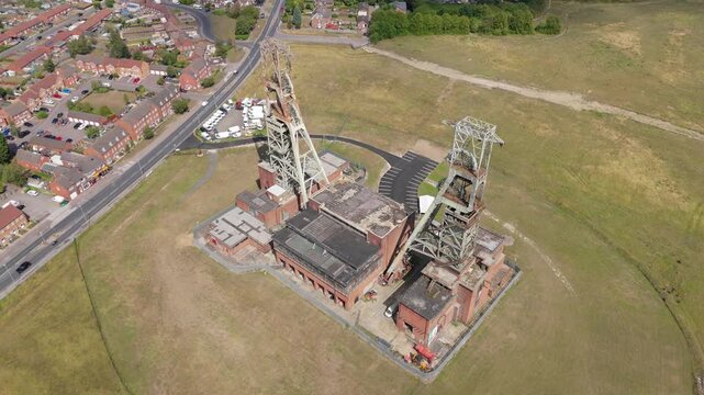 Aerial drone view of coal colliery mine site, industrial revolution legacy infrastructure extracting energy materials from earth Clipstone, Notttingham, England. 