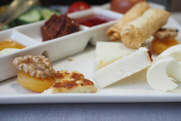 Cheese platter with assorted snacks and condiments