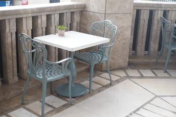 Outdoor cafe table and chairs set in a stylish setting