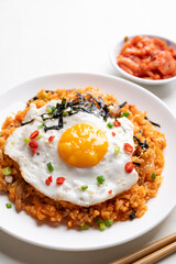 Korean kimchi fried rice with fried egg, pork, sesame seed, chili, spring onion and seaweed 