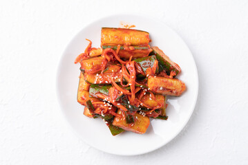 Top view of Korean kimchi cucumber on white plate, Korean side dish, Homemade food