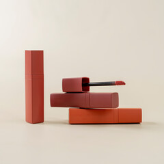 Three liquid lipsticks in matte reddish-brown shades arranged in a creative stack on a light beige...