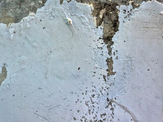 Peeling White Paint on a Concrete Wall