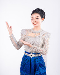 Portrait of Asian women with khmer traditional dress stand in front of pagoda with beautiful art...