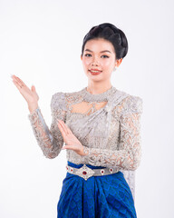 Portrait of Asian women with khmer traditional dress stand in front of pagoda with beautiful art...