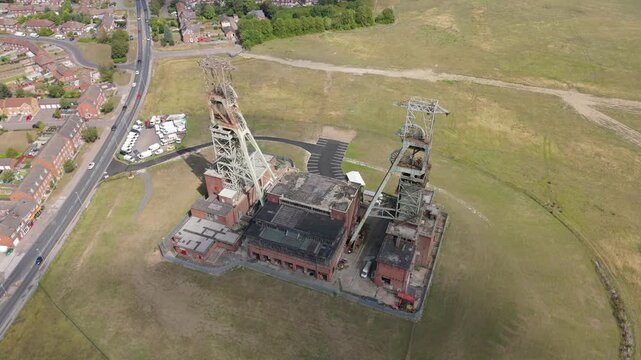 Aerial drone view of coal colliery mine site, industrial revolution legacy infrastructure extracting energy materials from earth Clipstone, Notttingham, England. 
