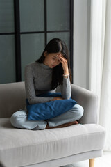 Young Asian Woman Feeling Lonely Sad Sick Stressed on Sofa at Home Alone for Healthcare Wellness...