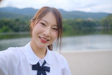 A young woman with long brown hair and a white shirt. A Student girl concept