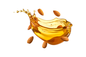 Fresh almonds splashing in a dynamic wave of golden almond oil isolated on transparent background