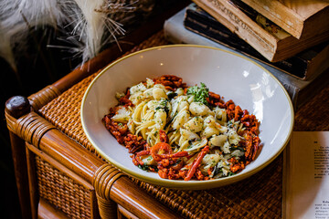 Rustic vegetable pasta bowl on vintage setup
