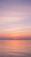 Fototapeta premium Ethereal Sunset Over Calm Ocean: A Symphony of Pastel Hues and Peaceful Reflections