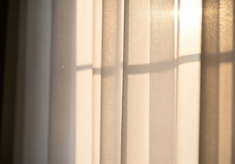 Fototapeta premium Sunlight Through White Curtains Warmth and Texture in Home Interior