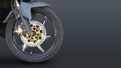 disc brake of the front wheel of a sports motorcycle. black motorcycle wheel showcases a sleek...