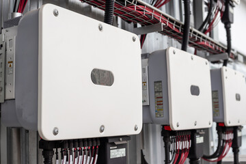 Inverter behind the solar panels. Renewable energy.Clean and Renewable energy concept.DC cable...