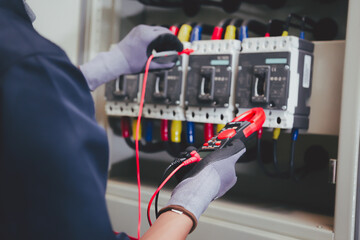 Professional electrician tests electrical installations. Measured with a multimeter to check...