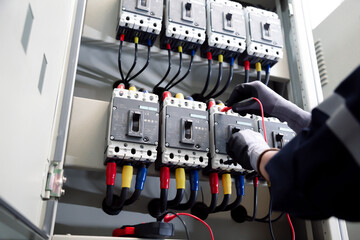 Professional electrician tests electrical installations. Measured with a multimeter to check...