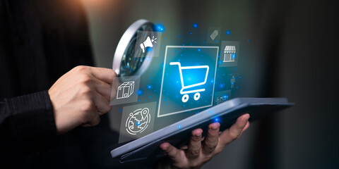 Holding a tablet with a holographic shopping cart icon and e-commerce symbols, representing online retail, digital marketing, and smart shopping technology for global business ,online business.