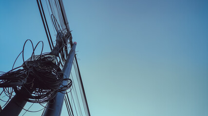 Industrial lattice tower for electricity distribution beneath vibrant blue sky, representing the...