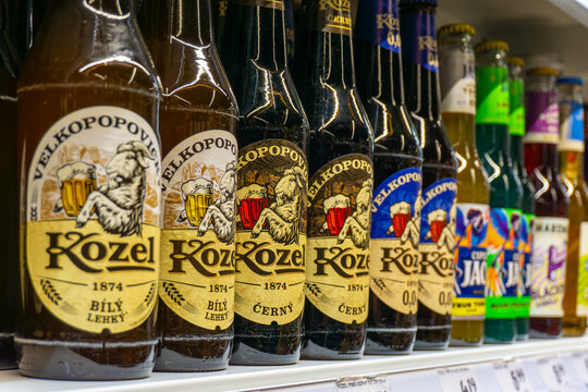 Velkopopovick&yacute; Kozel beer bottles on store shelf, various flavor and label variants, alcoholic beverages selection in Poland