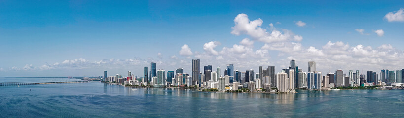 Fototapeta premium Aerial panorama of Brickell in Miami. Downtown Miami skyline on a sunny day. Scenic view of Miami Beach and Brickell. Brickell famous landmarks. Miami downtown landscape.