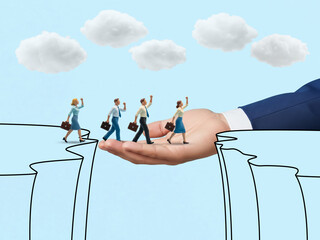 A giant hand helps a team of miniature business people cross a chasm, symbolizing mentorship and support to overcome business challenges and reach success.