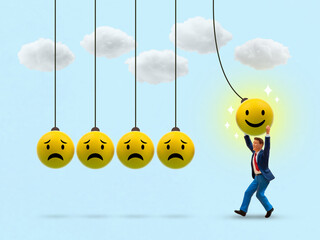 A conceptual image showing a miniature man pulling a happy face ball in a Newton's cradle to...