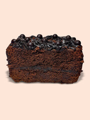 A slice of delicious Chocolate Sponge Cake on beige background. Close up view. National Chocolate...