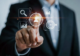 Businessman touching a digital interface with business analytics and target icons