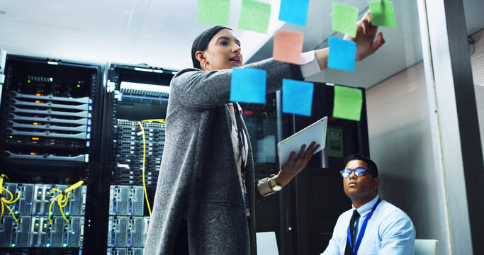 People, IT engineer and planning with sticky note in server room for priority on network security. Technician, team or cybersecurity agency brainstorming with tablet for troubleshooting in datacenter