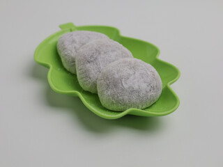 Mochi or Japanese rice cake made from glutinous flour on green plate