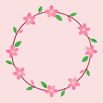 Pink cherry blossom wreath with green leaves on pastel background