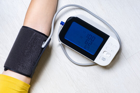 Man check blood pressure monitor and heart rate monitor with digital pressure gauge. Health care and Medical concept - Powered by Adobe