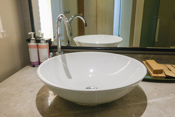 Modern bathroom with a stylish white vessel sink and sleek fixtures.