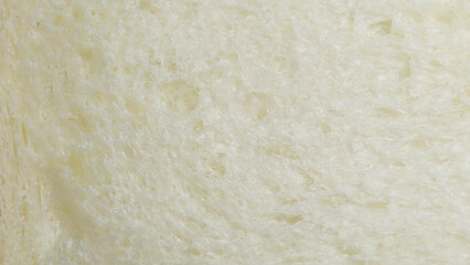 Macro shot golden-yellow tint bread slice. Textured surface bread's interior, showing its porous,...