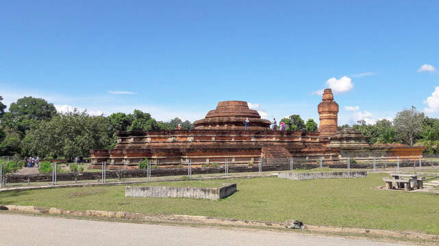 Kampar, Riau, Indonesia. Jul 1, 2017. Muara Takus Temple complex, an ancient Buddhist heritage site built of red bricks, surrounded by greenery, under a bright blue sky, visited by tourists.