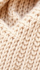 A close up shot showcasing the intricate details of a knitted cream colored wool fabric texture pattern