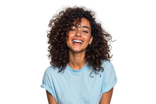 Happy young woman with curly brown hair laughing joyfully. Cheerful and natural female beauty with a genuine smile in a studio shot