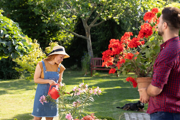 Woman watering flowers in vibrant garden