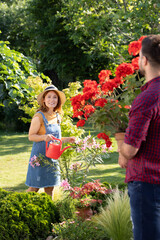 Woman watering flowers in vibrant garden