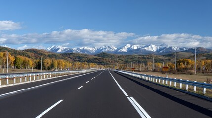 Asphalt highway stretches to snow-capped mountains