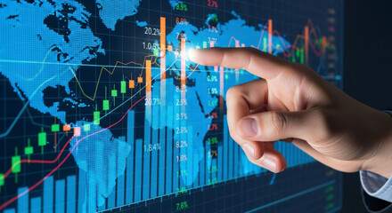 A man's hand pointing at a futuristic holographic screen displaying global financial charts, stock market data, and a world map